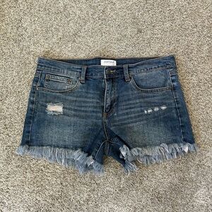 JUSTUSA cut off raw hem jeans shorts. Minor distressing. Stretch. Medium rise